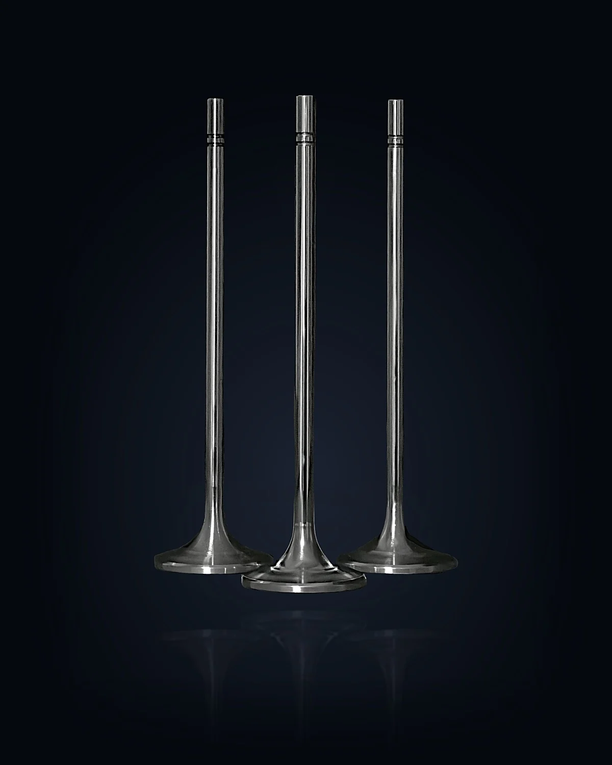 Three TripleHard® coated engine valves, studio-lit against the page background