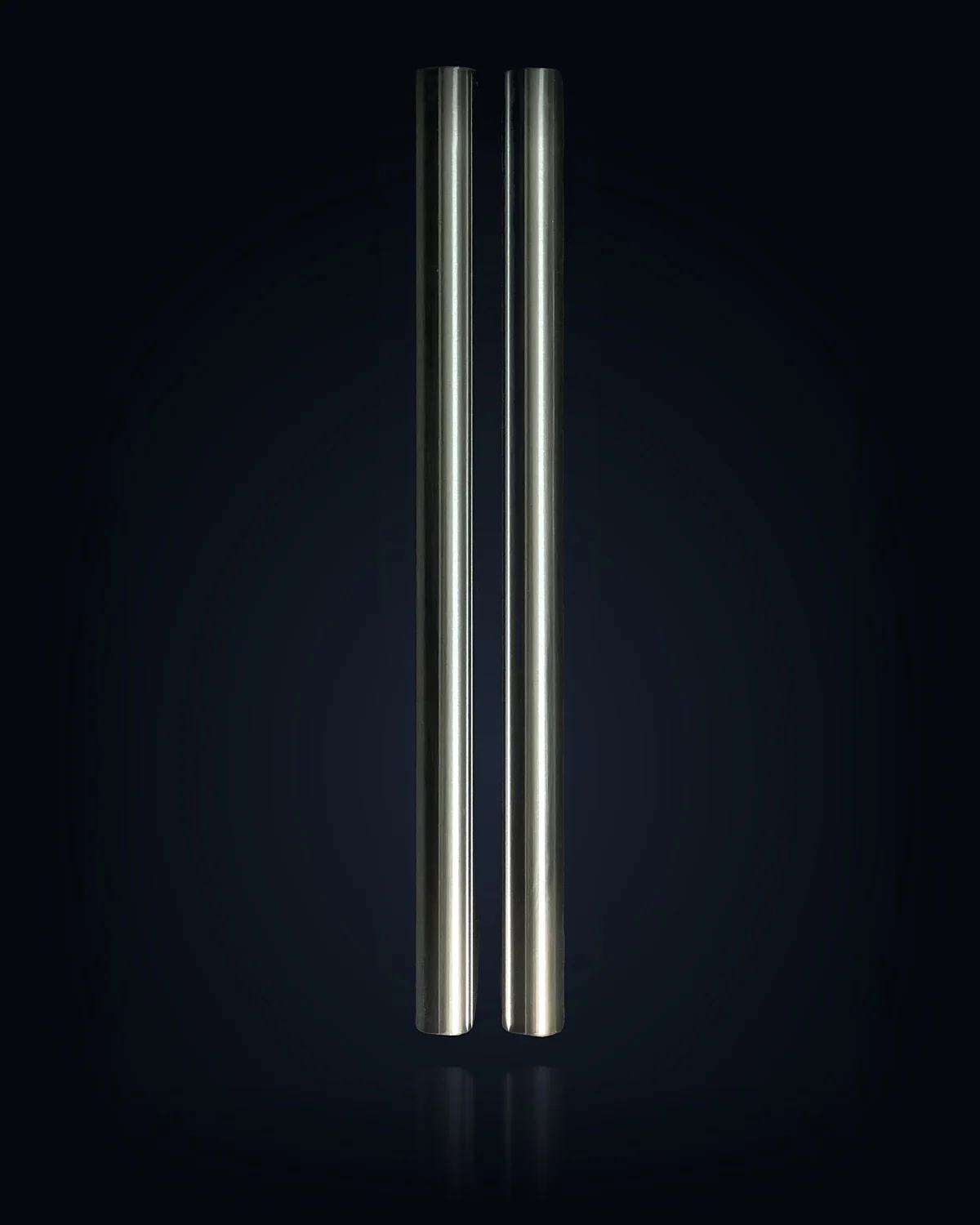 Two TripleHard® coated hydraulic cylinder rods, studio-lit against the page background